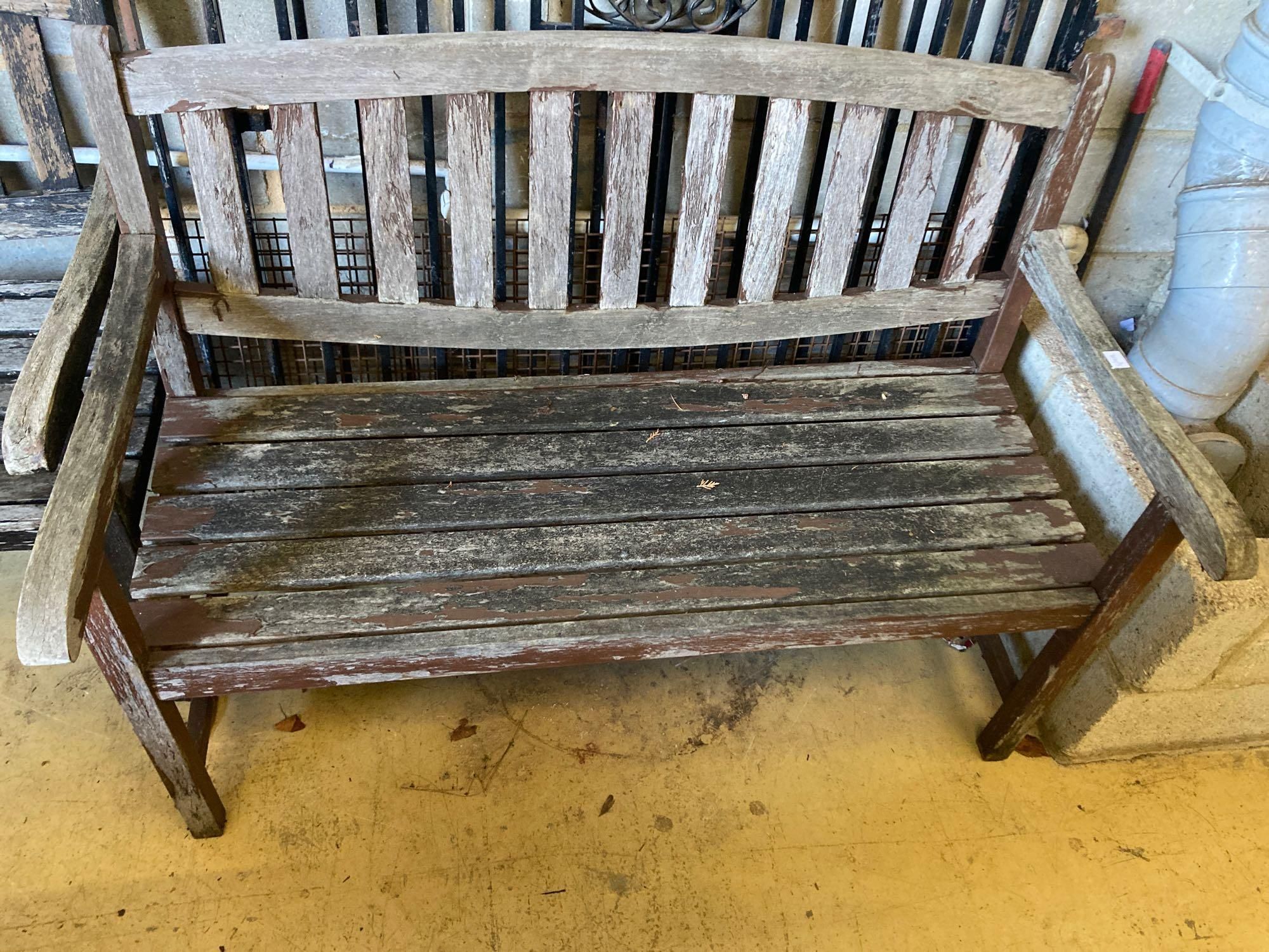 Two stained teak garden benches and matching armchairs, bench widths 126cm and 123cm